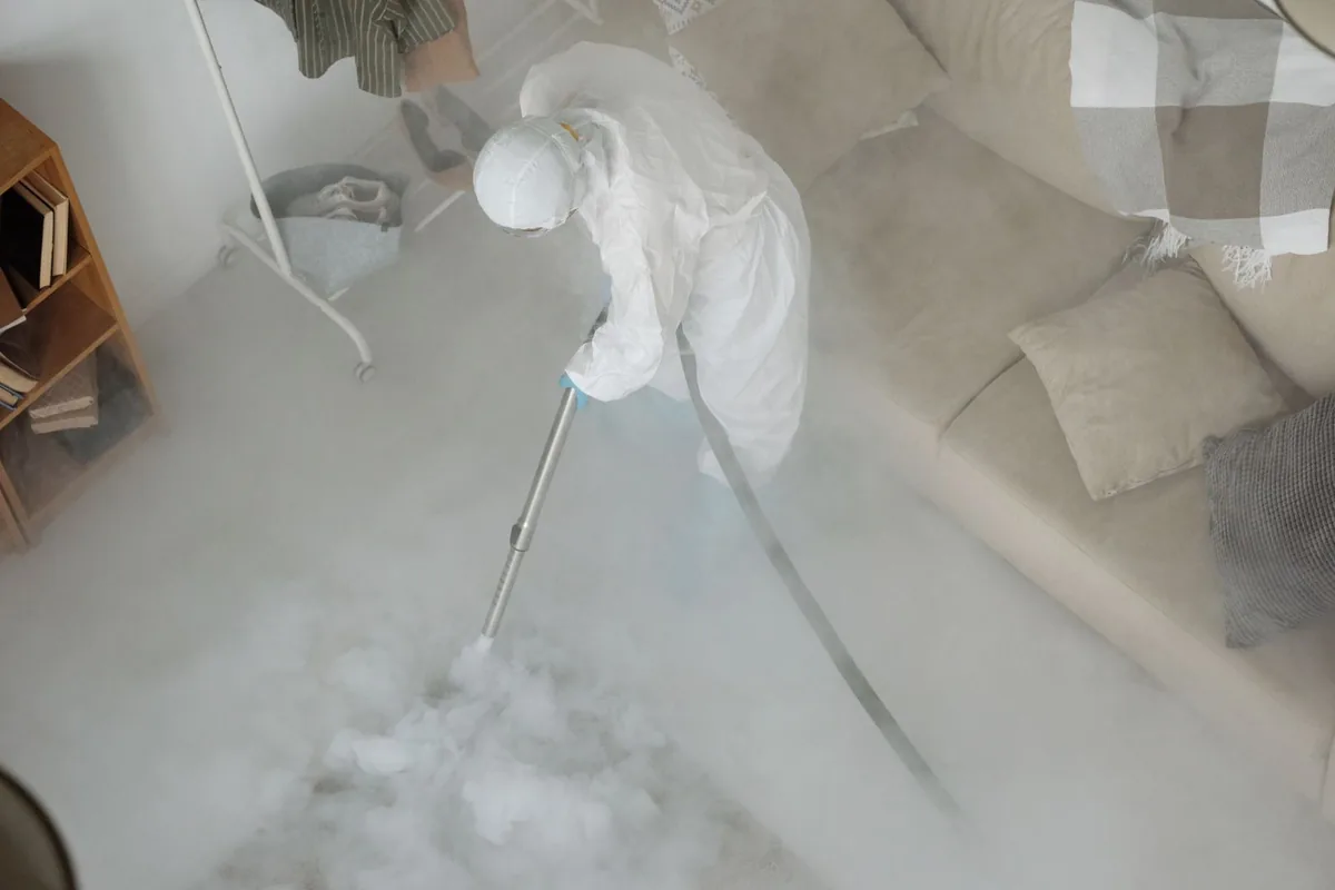 Biohazard cleanup technician in protective equipment, Colma, CA